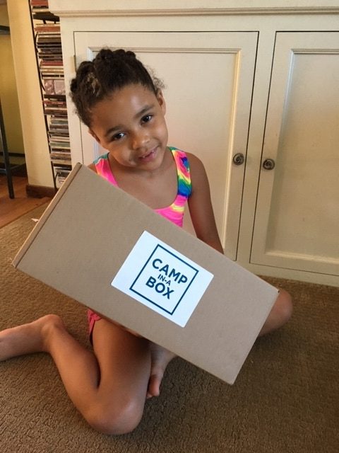 cute 7 year old girl holding box