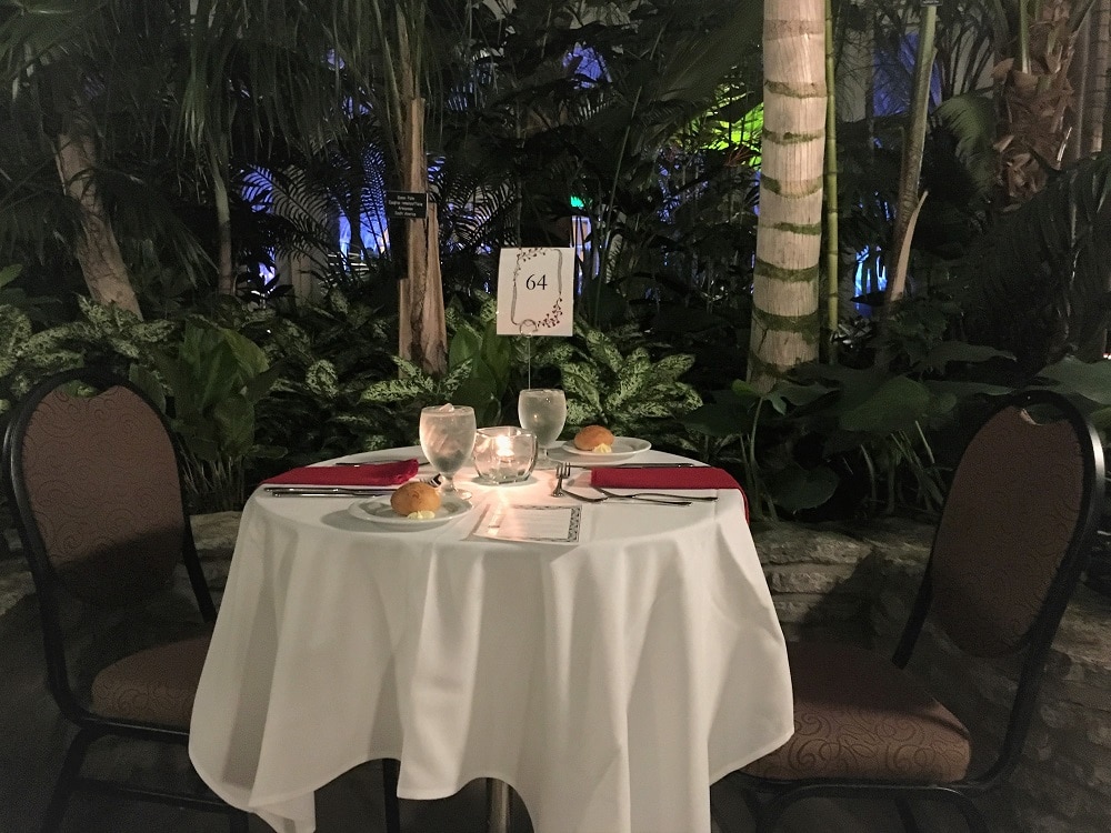 table set up for two dinner in tropical setting