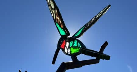 A glass hummingbird against the blue sky